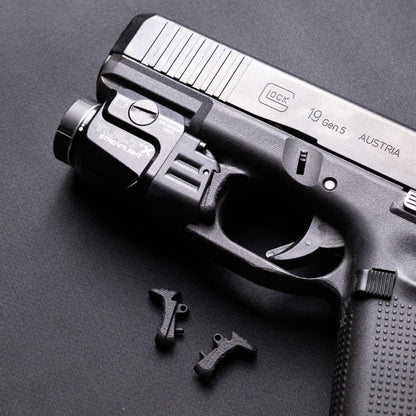 Glock 19 with Streamlight TLR‑7X and ČVIRIQ -Extended Streamlight TLR‑7X switches.