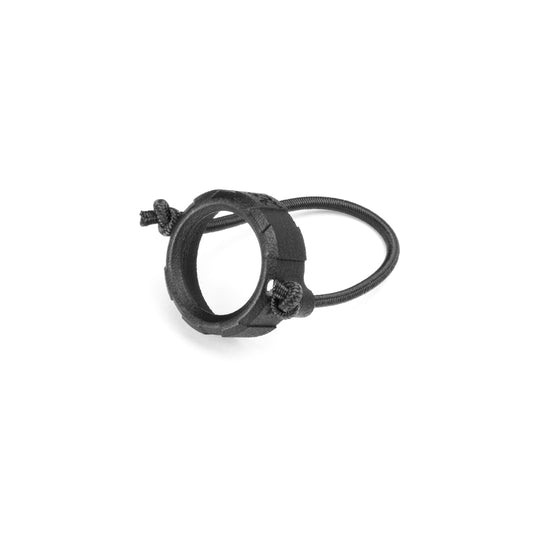 A black protective glass lens for a red dot sight with a bungee cord and a plastic ring.